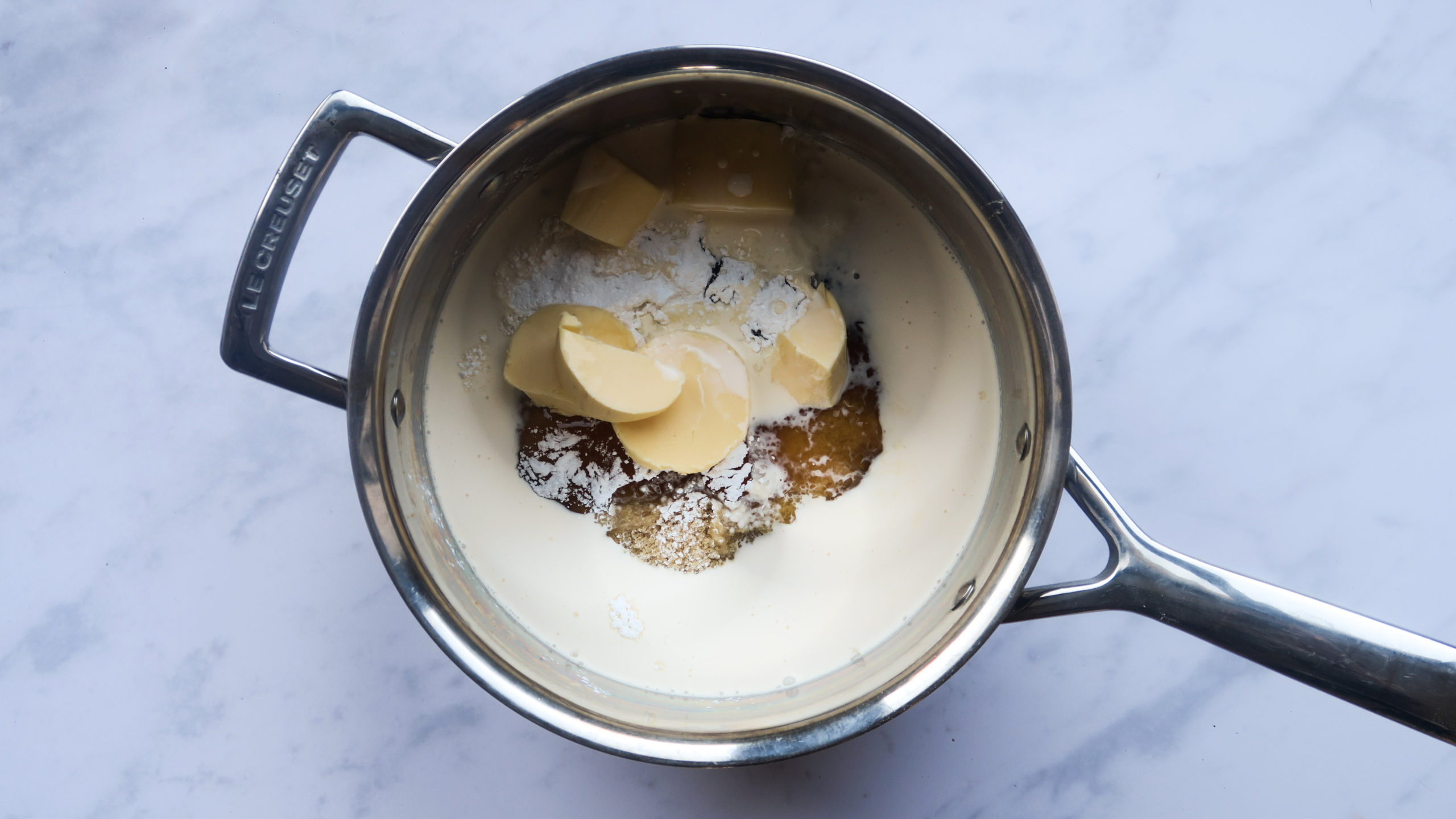 the dairy and sugar melting in a pan