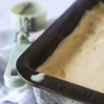 Ice cream in a loaf tin with a green ice cream scoop