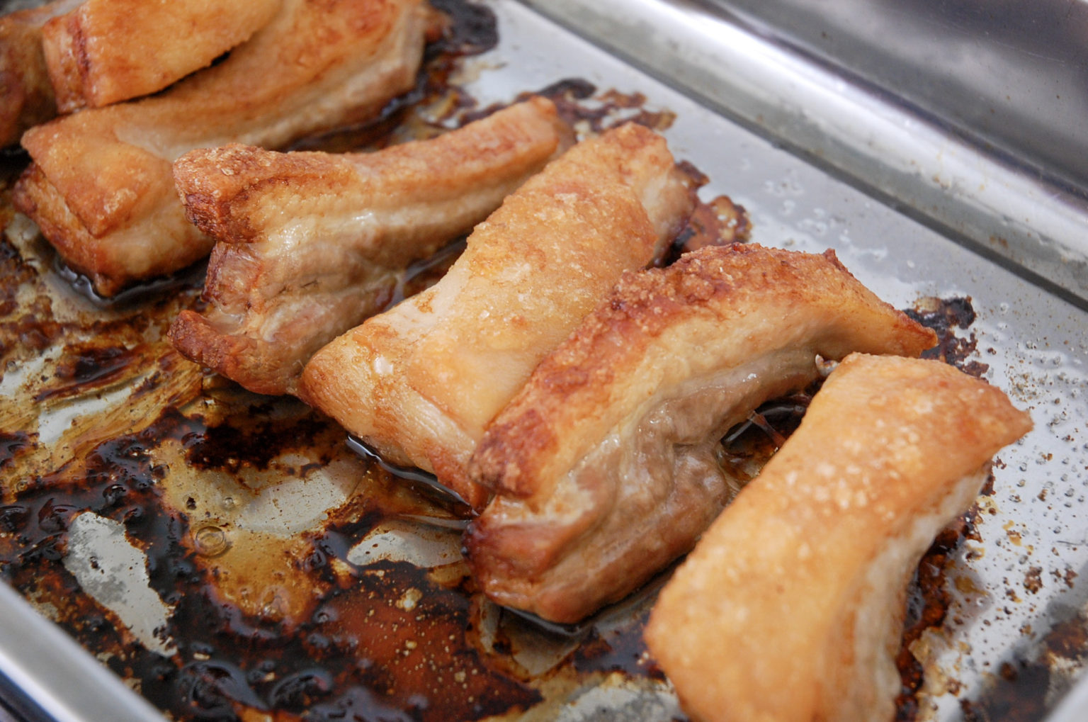 crispy pork belly slices in a baking tray