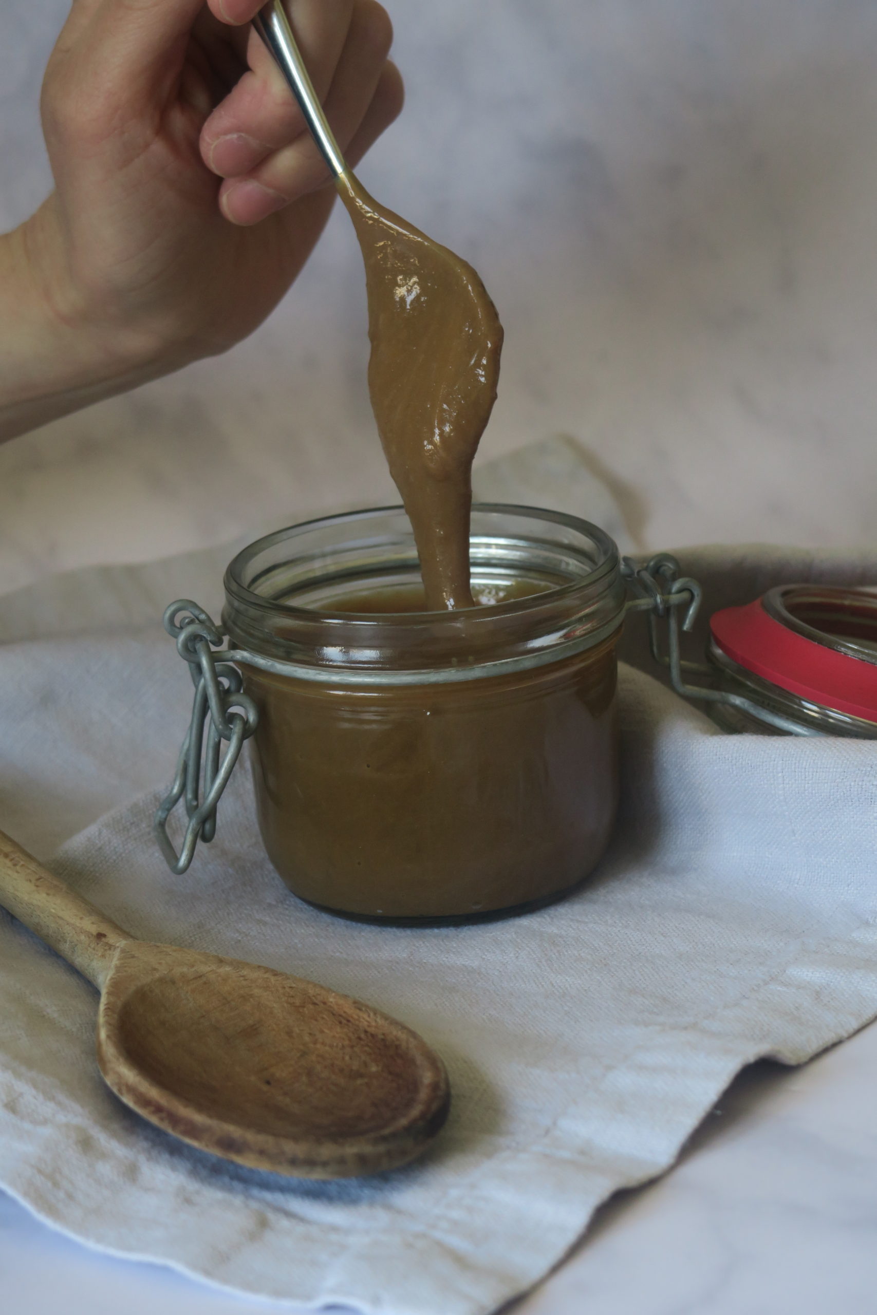 a spoon dipped into the sauce to show how thick it is