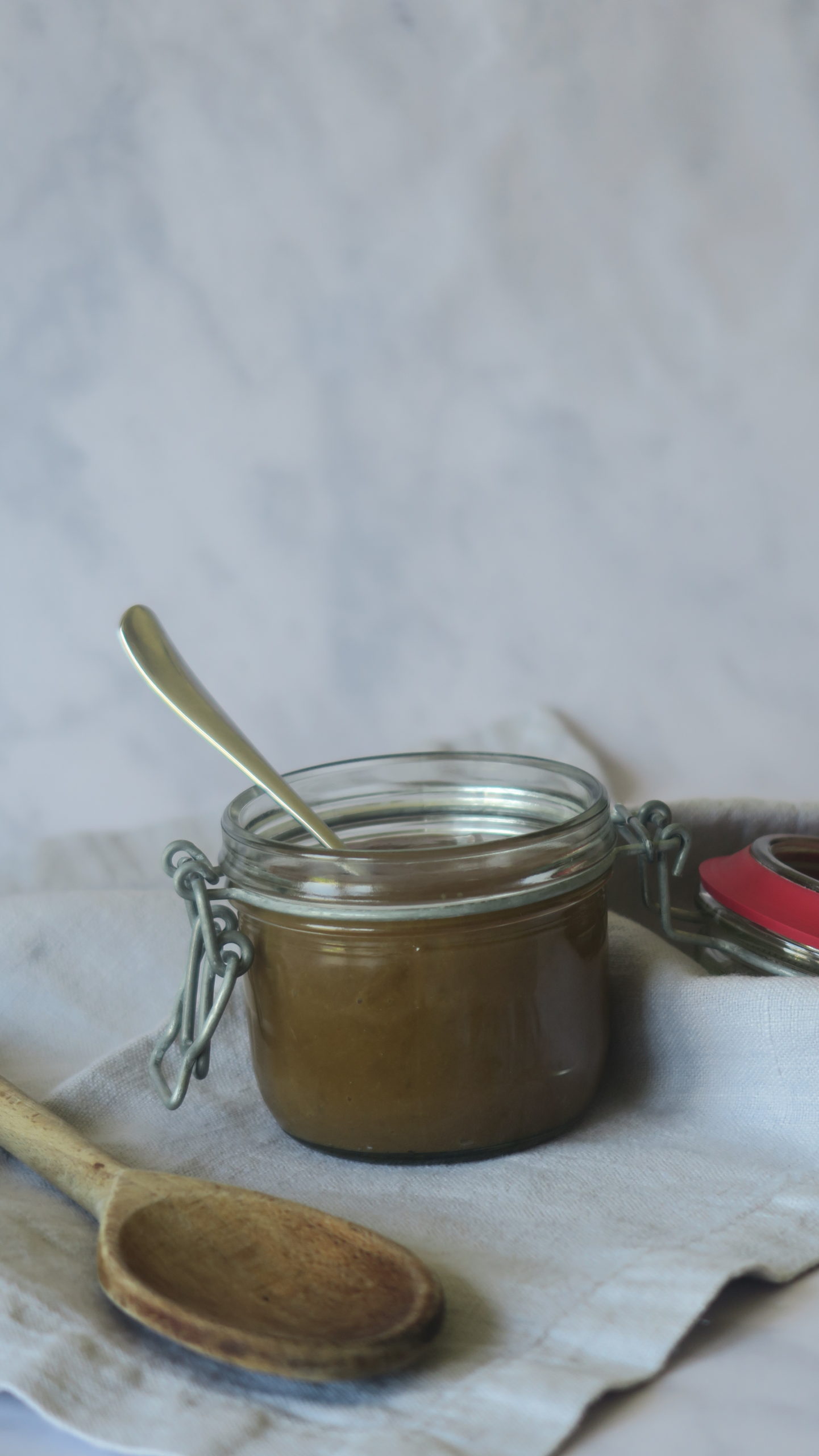 Dulce de leche jar with a wooden spoon