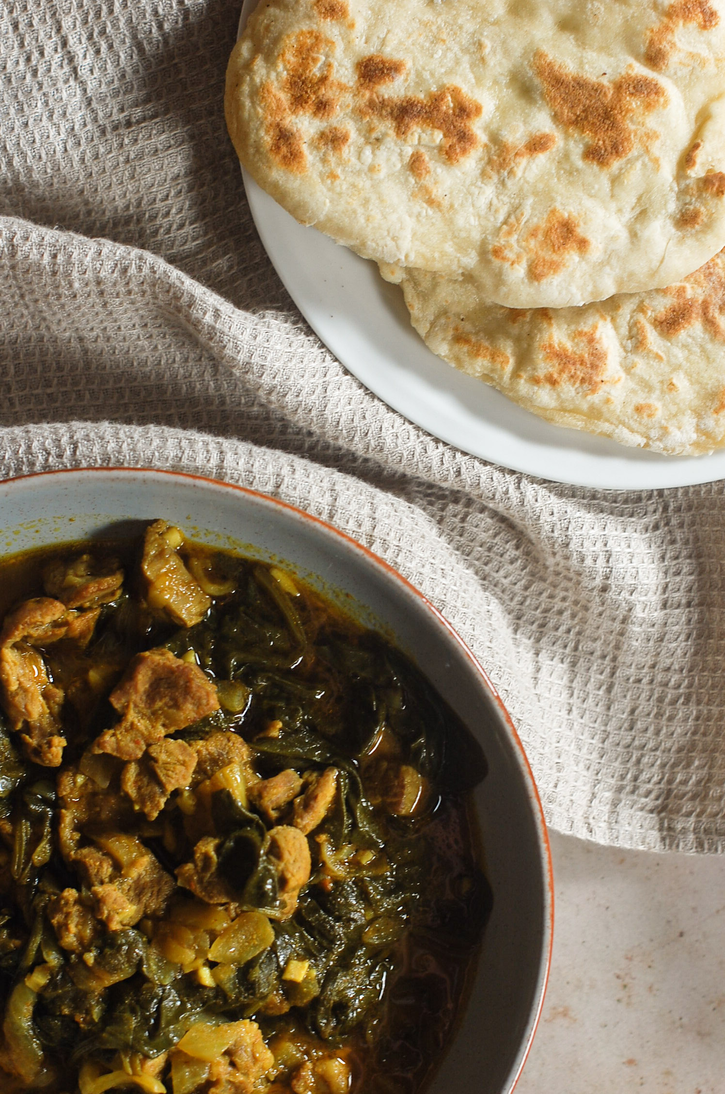 Lamb and spinach curry with naan bread