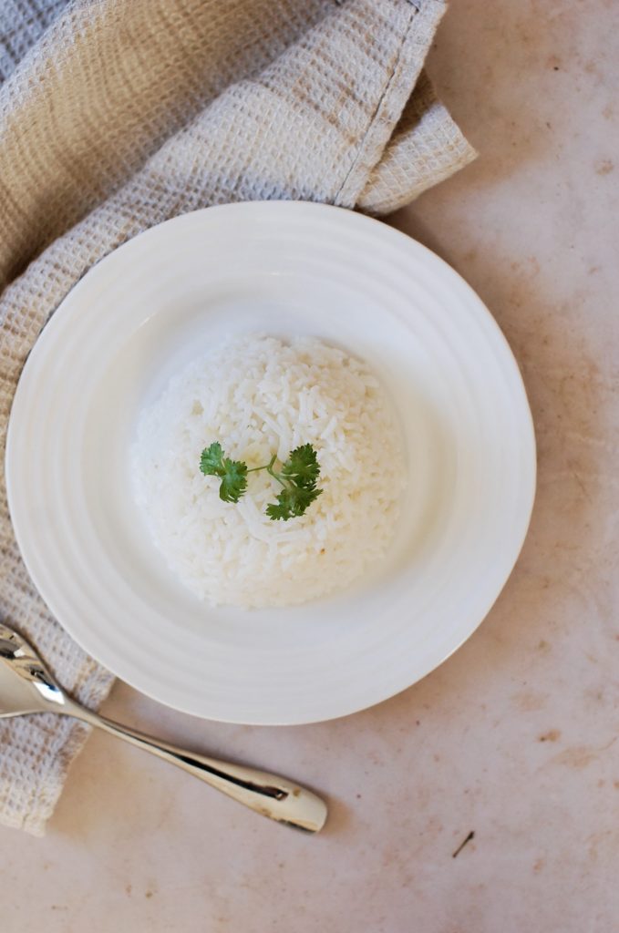 A plate of white rice in the shape of a dome.