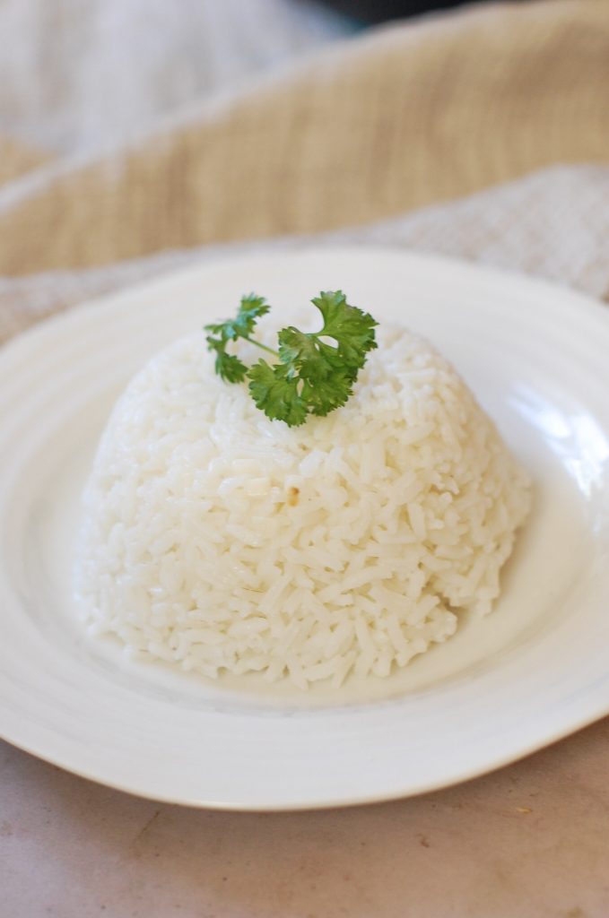 A dome of Brazilian white rice on a white plate. 