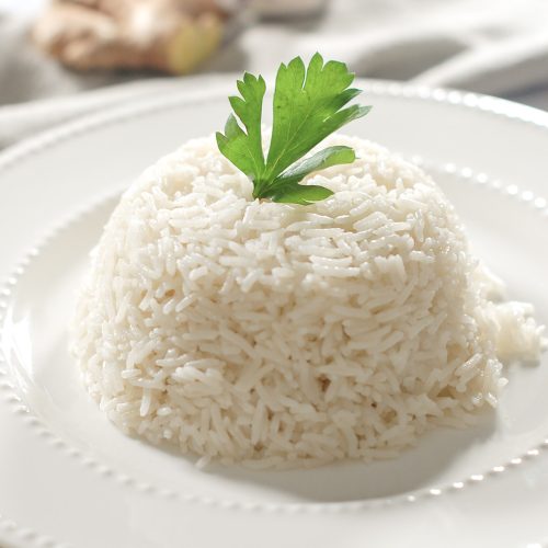A dome of coconut rice dressed with a parsley leaf