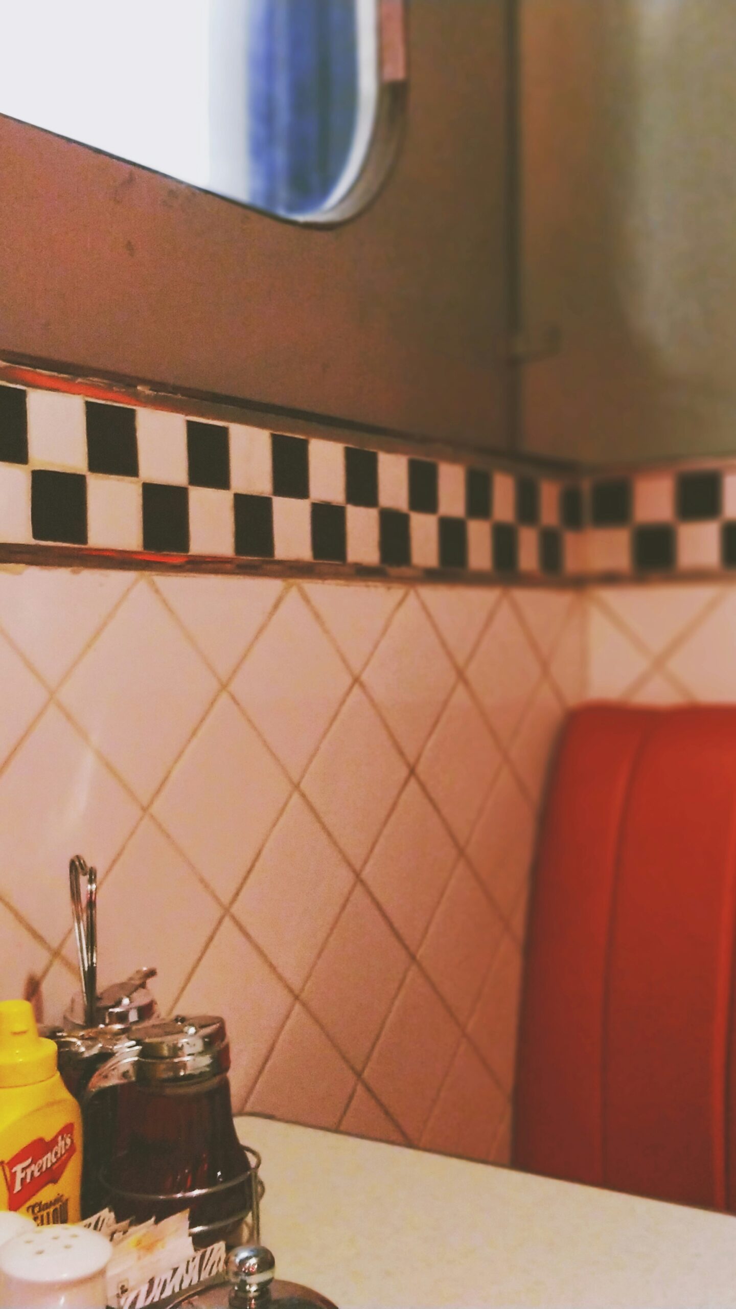 The white tiles and red seats found in a diner